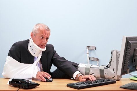 Photo of a mature businessman with multiple injuries sitting at